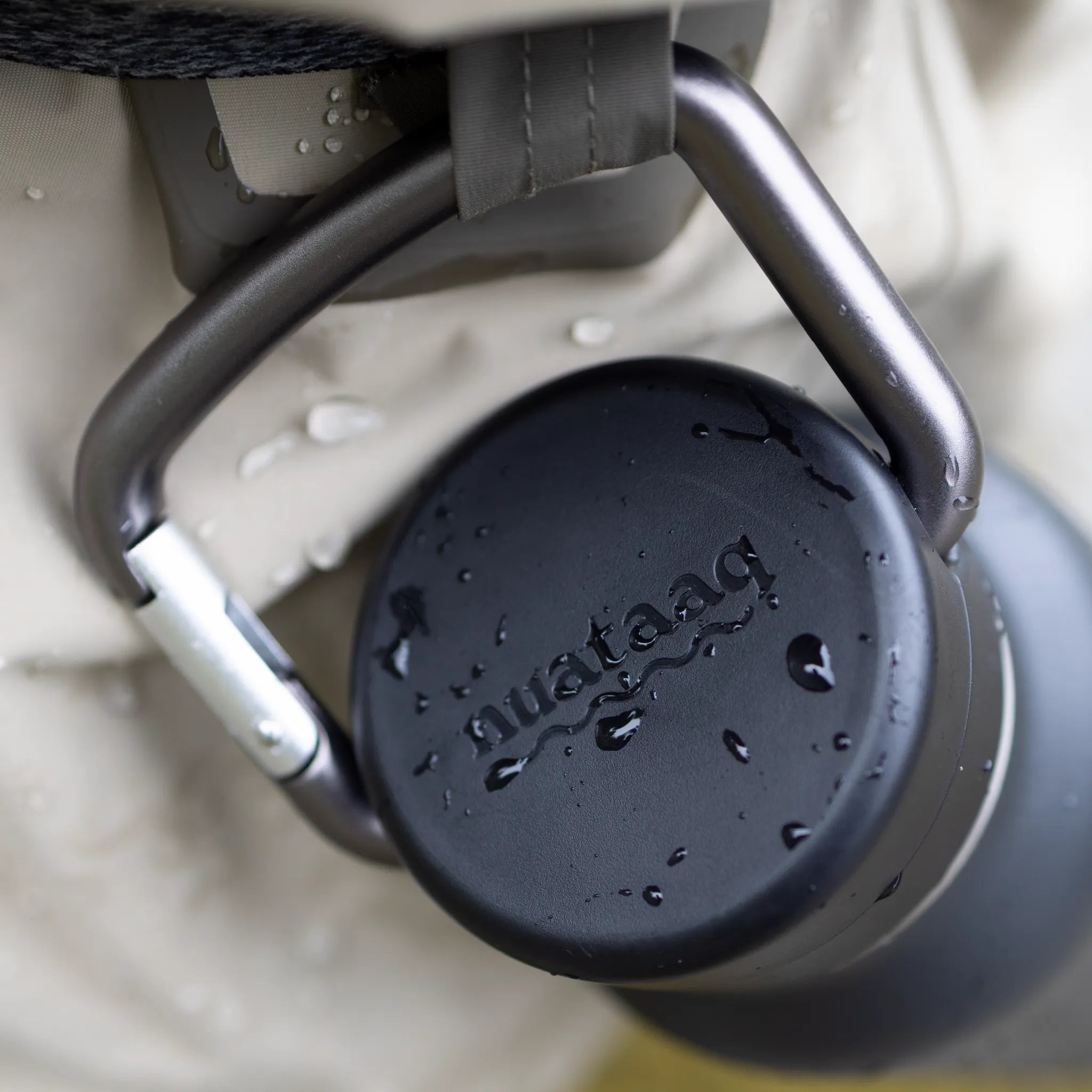 close up of carabiner bottle clipped to waders