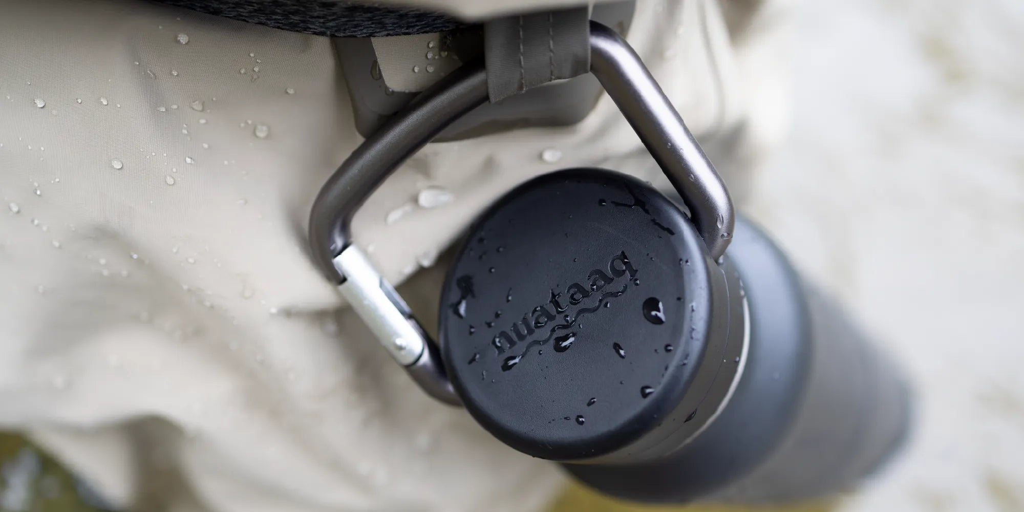 Black carabiner bottle attached to the waist belt of a fisherman